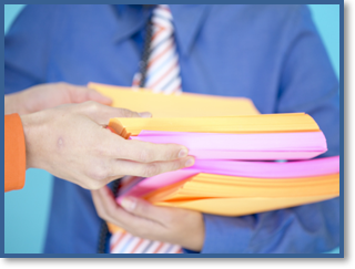 A Manager distributes handouts for a presentation.