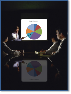 A Manager uses a projector to display a computer-generated pie chart during a presentation.
